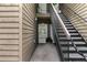 Condo entrance with exterior staircase leading to upper-level units, showcasing the building's layout and design at 605 Parkaire Xing, Marietta, GA 30068