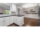 Updated eat-in kitchen view from behind the counter, hardwood floors, and stylish pendant lighting at 605 Parkaire Xing, Marietta, GA 30068