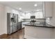 Modern kitchen with stainless steel appliances, dark countertops, and white cabinetry at 605 Parkaire Xing, Marietta, GA 30068