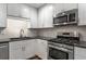 Modern kitchen featuring stainless steel appliances, modern cabinets, and dark countertops at 605 Parkaire Xing, Marietta, GA 30068