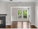 Bright living room space with hardwood floors, large windows, and a glimpse of the outdoors at 605 Parkaire Xing, Marietta, GA 30068