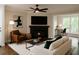 Cozy living room featuring a fireplace, modern decor, and a comfortable seating area for relaxing at 605 Parkaire Xing, Marietta, GA 30068