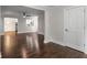 Open-concept living space with hardwood floors, leading into dining and kitchen areas, perfect for entertaining at 605 Parkaire Xing, Marietta, GA 30068