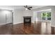 Spacious living room featuring hardwood floors, a cozy fireplace, and natural light from large windows at 605 Parkaire Xing, Marietta, GA 30068
