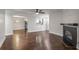 Open-concept living room with hardwood floors, fireplace, and views into the dining area and kitchen at 605 Parkaire Xing, Marietta, GA 30068