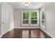 Bright room with hardwood floors, big windows, and a door; showcasing natural light and neutral walls at 605 Parkaire Xing, Marietta, GA 30068