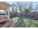 Backyard featuring a cozy porch, green lawn, and privacy fence at 660 Delbridge Nw St, Atlanta, GA 30314
