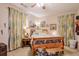 Comfortable bedroom with charming decor, wood furniture, and light-filtering curtains at 660 Delbridge Nw St, Atlanta, GA 30314