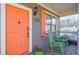 Charming front porch with bright orange door, rocking chairs, and 'Vine City' sign at 660 Delbridge Nw St, Atlanta, GA 30314