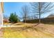 Large backyard featuring a patio area, mature trees, and privacy fencing for outdoor enjoyment at 335 Roberts Run Cv, Suwanee, GA 30024