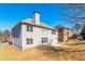 Exterior home view showcasing a patio and spacious backyard with mature trees at 335 Roberts Run Cv, Suwanee, GA 30024