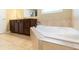 A bathroom featuring a tiled floor and a large bathtub set against a vanity at 335 Roberts Run Cv, Suwanee, GA 30024
