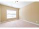 Bright bedroom features carpet floors, neutral walls, and a large window at 335 Roberts Run Cv, Suwanee, GA 30024