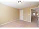Neutral bedroom with access to hallway, neutral walls and neutral carpet at 335 Roberts Run Cv, Suwanee, GA 30024