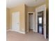 Bedroom with neutral walls and carpet with doorways to other rooms at 335 Roberts Run Cv, Suwanee, GA 30024