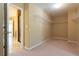 A closet with neutral walls, shelving, and carpeted flooring, providing ample storage space at 335 Roberts Run Cv, Suwanee, GA 30024