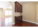 Dining area featuring hardwood floors and a built-in cabinet with granite countertop at 335 Roberts Run Cv, Suwanee, GA 30024