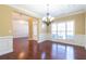 Formal dining room featuring hardwood floors, wainscoting, chandelier, and bright light at 335 Roberts Run Cv, Suwanee, GA 30024