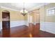 Dining room with hardwood floors, decorative trim, and elegant chandelier lighting at 335 Roberts Run Cv, Suwanee, GA 30024