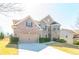 Beautiful two-story brick home with an attached garage and a neatly landscaped front yard at 335 Roberts Run Cv, Suwanee, GA 30024