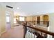 View of the carpeted hallway with dark brown metal railings that lead to a living area and a laundry nook at 335 Roberts Run Cv, Suwanee, GA 30024