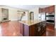 Large kitchen island with granite countertops, dark wood cabinets, and open floor plan at 335 Roberts Run Cv, Suwanee, GA 30024