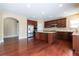Open kitchen with stainless appliances, granite island, and dark wood cabinets at 335 Roberts Run Cv, Suwanee, GA 30024