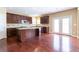 Spacious kitchen with dark wood cabinets, stainless steel appliances, and a center island at 335 Roberts Run Cv, Suwanee, GA 30024