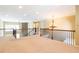 Open living room with staircase, stone wall, chandelier, and natural light at 335 Roberts Run Cv, Suwanee, GA 30024