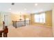 Bright living room with chandelier, staircase, and large window at 335 Roberts Run Cv, Suwanee, GA 30024