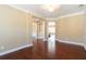 Open-concept living space with hardwood floors, neutral walls, and seamless flow at 335 Roberts Run Cv, Suwanee, GA 30024