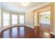 Spacious living room boasts gleaming hardwood floors, natural light, and elegant molding at 335 Roberts Run Cv, Suwanee, GA 30024