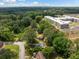 Community aerial view shows lush trees surrounding property with apartment building and single-Gathering homes at 3964 Gretna Green Dr, Decatur, GA 30035
