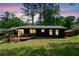 Night view of cozy backyard with deck on a dark grey home and green grass at 3964 Gretna Green Dr, Decatur, GA 30035
