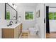 Bright and modern bathroom with double sink vanity, large mirror, and a view from the window at 3964 Gretna Green Dr, Decatur, GA 30035