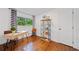 Bright bedroom featuring a wood desk, shelves with decor, hardwood floors, and natural light from the window at 3964 Gretna Green Dr, Decatur, GA 30035