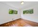 Bright bedroom featuring hardwood floors and large windows offering pleasant views of the outdoors at 3964 Gretna Green Dr, Decatur, GA 30035