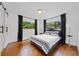 Comfortable bedroom with hardwood floors, natural light from two windows, and minimalist design at 3964 Gretna Green Dr, Decatur, GA 30035