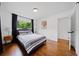 Bright bedroom features hardwood floors, a large window and a comfortable bed at 3964 Gretna Green Dr, Decatur, GA 30035