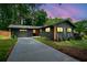 Charming house with long driveway and manicured lawn surrounded by lush trees at 3964 Gretna Green Dr, Decatur, GA 30035