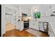 Modern kitchen with white cabinets, stainless steel appliances, marble backsplash, and wood flooring at 3964 Gretna Green Dr, Decatur, GA 30035