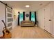 Bright living room with hardwood floors, sliding barn door and a neutral colored sofa at 3964 Gretna Green Dr, Decatur, GA 30035