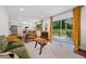 Open-concept living room with hardwood floors, bright windows, access to a patio, and seamlessly connected to the kitchen at 3964 Gretna Green Dr, Decatur, GA 30035