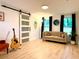 Light filled living room with a sliding barn door, neutral walls and light floors at 3964 Gretna Green Dr, Decatur, GA 30035