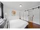 Cozy main bedroom featuring a sliding barn door leading to the en-suite bathroom and shower at 3964 Gretna Green Dr, Decatur, GA 30035