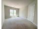 A bright bedroom with a large window and white trim, ready for personalized touches at 4125 Sierra Vista Cir, Cumming, GA 30040