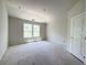 A minimalist bedroom with a large window for natural light and a paneled door at 4125 Sierra Vista Cir, Cumming, GA 30040