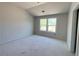 Bright bedroom features a large window, neutral walls, and vaulted ceiling at 4125 Sierra Vista Cir, Cumming, GA 30040