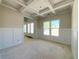 An unfinished dining room features white walls, wainscoting, and a coffered ceiling at 4125 Sierra Vista Cir, Cumming, GA 30040