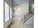 A foyer with views of a staircase with wood and metal railings, wainscotting, and a coffered ceiling at 4125 Sierra Vista Cir, Cumming, GA 30040